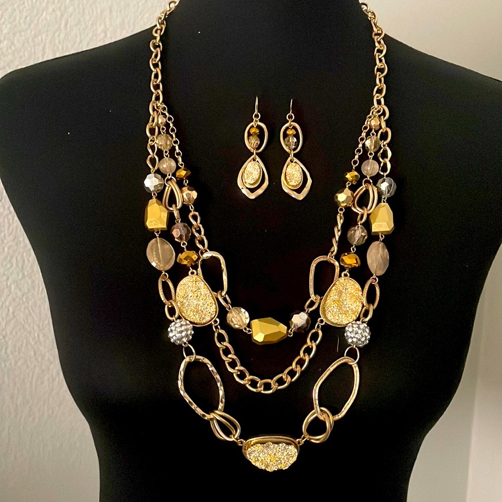 3 tier gold necklace with matching earrings.